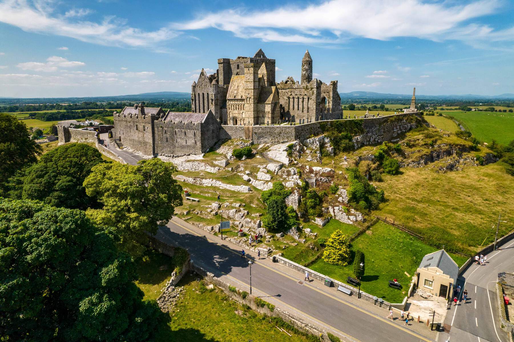 The historic Rock of Cashel, a medieval fortress and monastery, perched atop a limestone outcrop in County Tipperary, Ireland, with its stone walls, towers, and Romanesque chapel. 