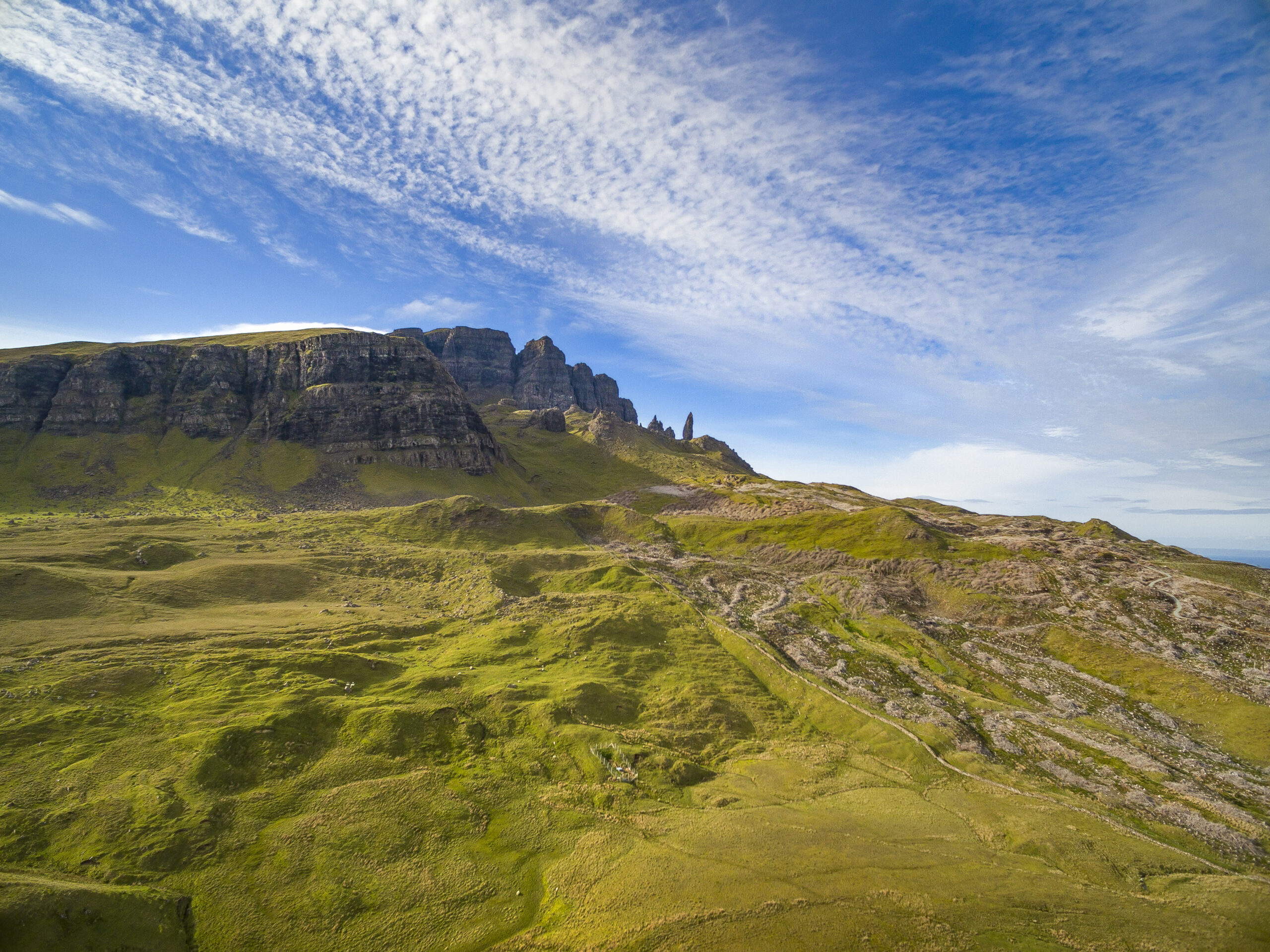 The iconic Old Man of Storr, a majestic rock formation on the Isle of Skye, Scotland, standing amidst rugged landscape and misty hills, a popular hiking destination. 