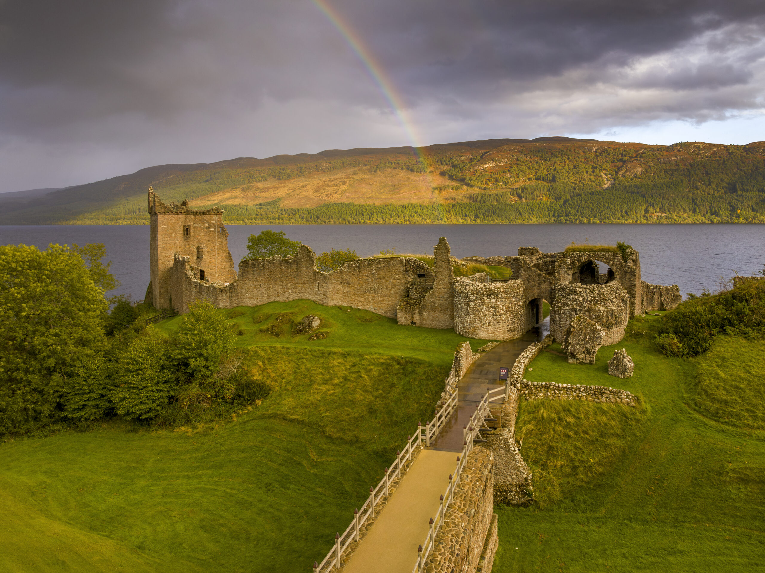 Urquhart Castle, a ruin, is located beside Loch Ness in Scottish Highlands.