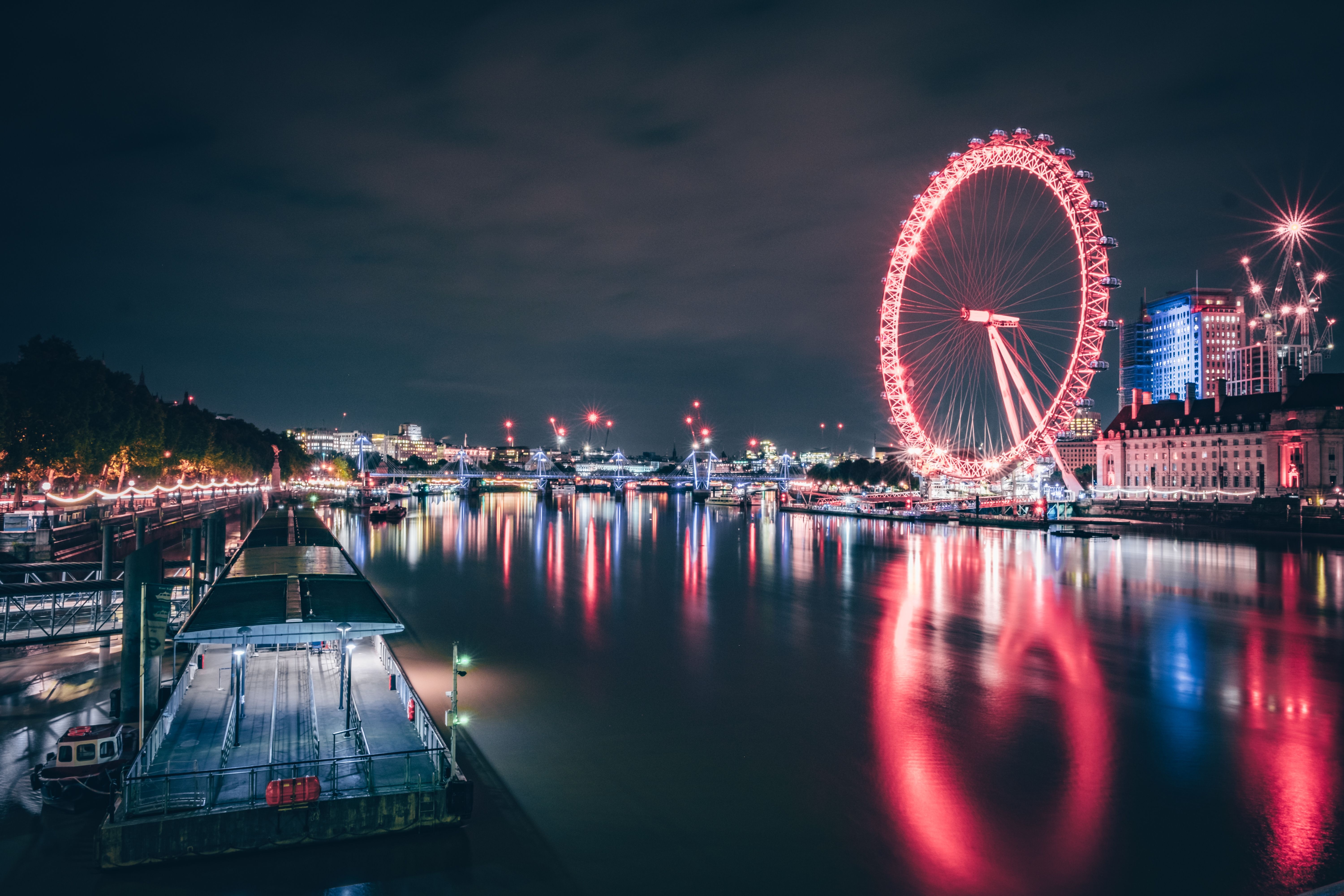 London Eye lit up at night, London England UK, iconic landmark and tourist attraction