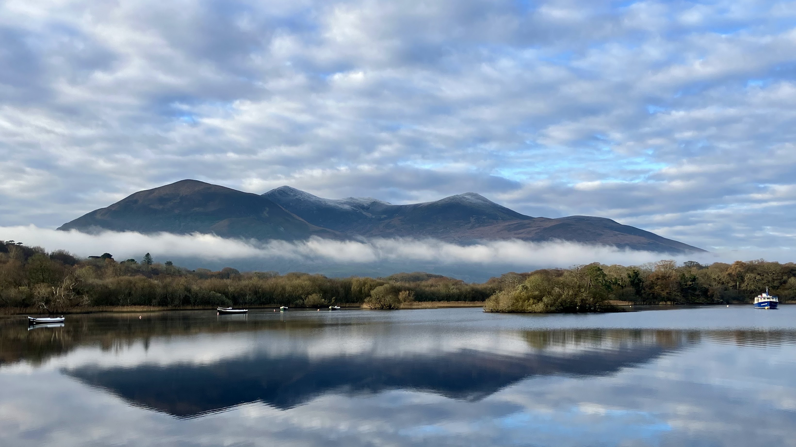 Breathtaking view from Ross Castle, showcasing lakes, mountains, and lush greenery in Killarney National Park, County Kerry, Ireland