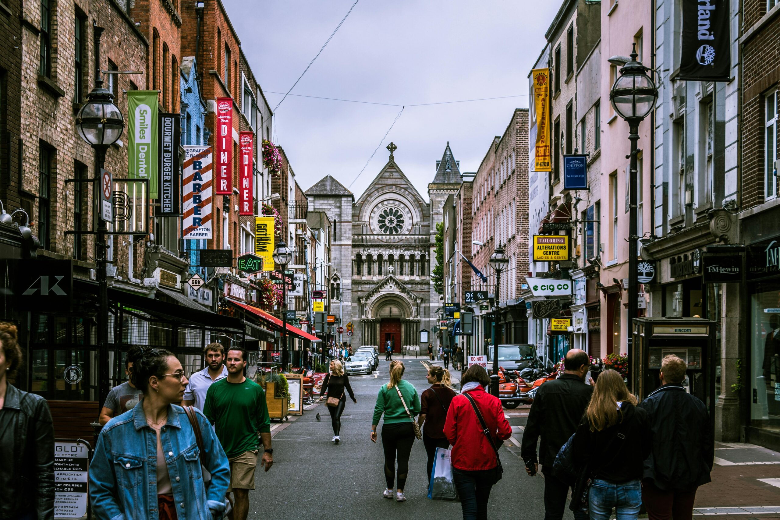 A colorful and vibrant cityscape of Dublin, Ireland with historic buildings, quaint shops, and lively street life in the background. 