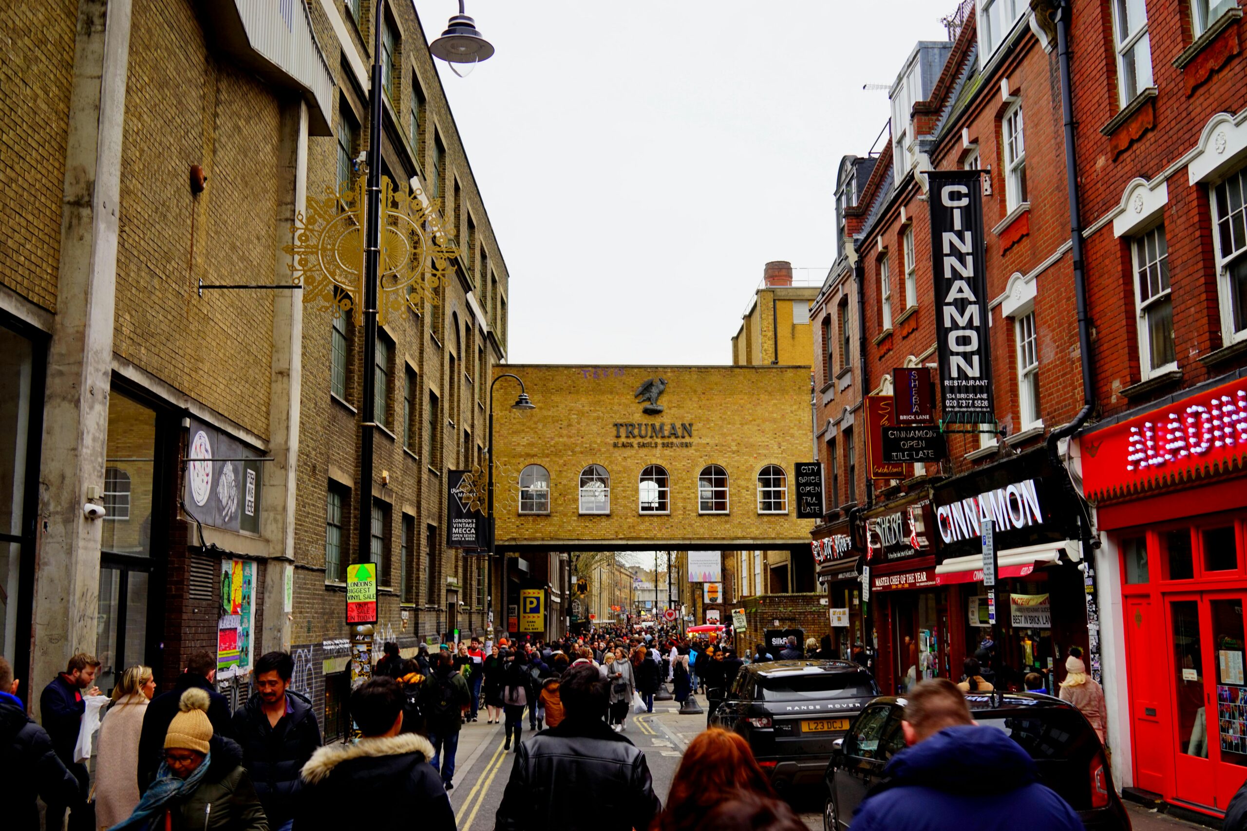 Vibrant London street scene, with historic buildings, bustling crowds and classic red phone booths, capturing the city's unique blend of tradition and urban energy.