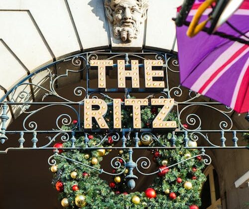 London Christmas decorations: The Ritz hotel festive garland and neon sign, a iconic holiday sight in London, England, UK