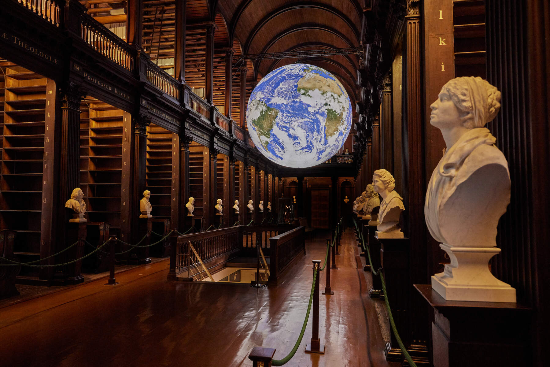 Illuminated Gaia Earth sculpture at Trinity College Cambridge, a large inflated globe displaying vibrant oceans and continents, artist Luke Jerram's stunning installation.